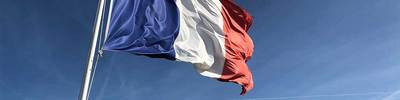 The flag of France hangs on a flagpole